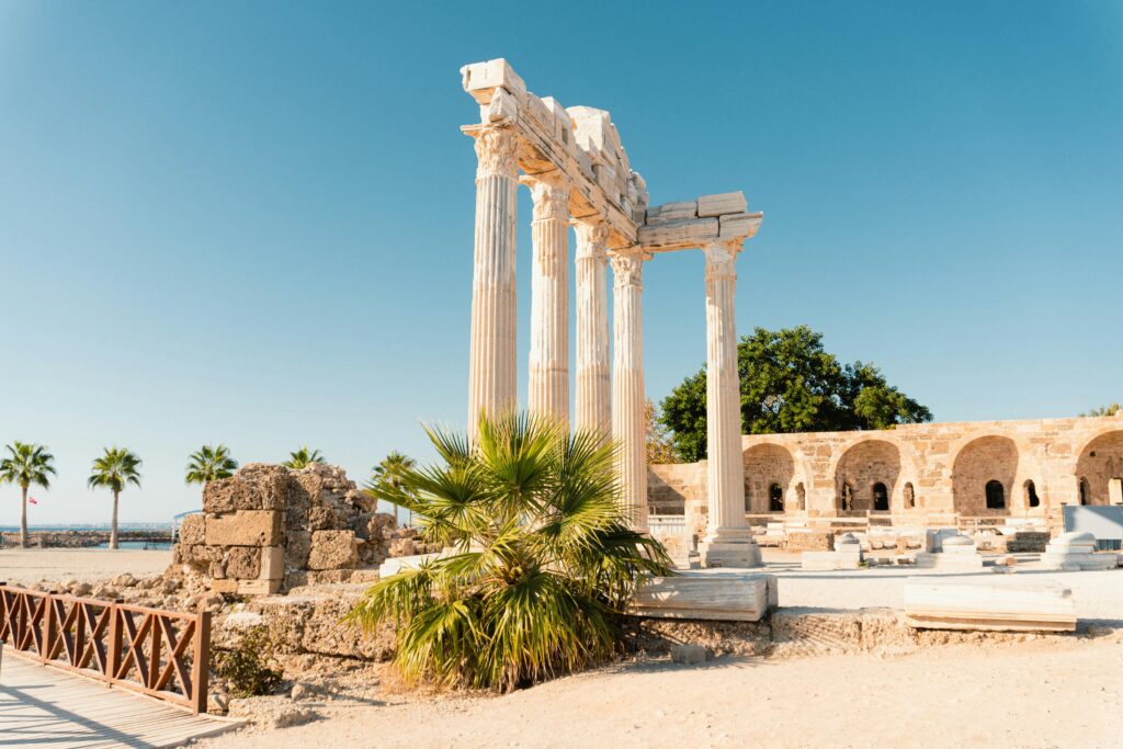 Discover the ancient ruins of the Temple of Apollo in Side, Antalya, against a clear blue sky.