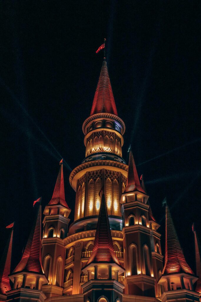A stunning night view of illuminated towers in Antalya's theme park, showcasing architectural beauty.
