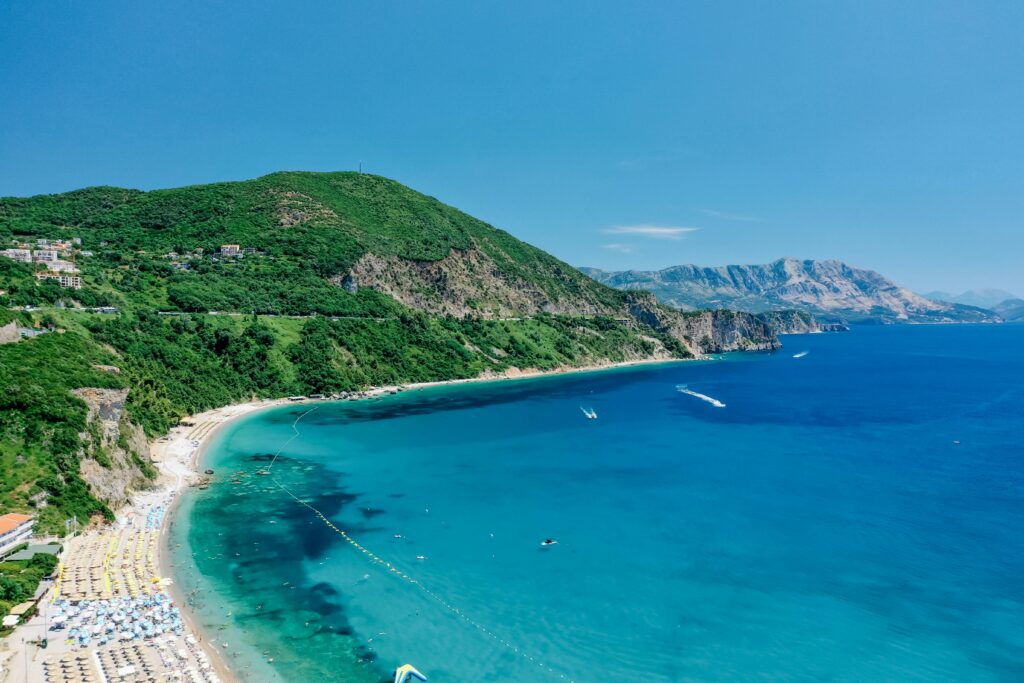 Stunning aerial drone view of a coastal beach in Montenegro with turquoise waters.